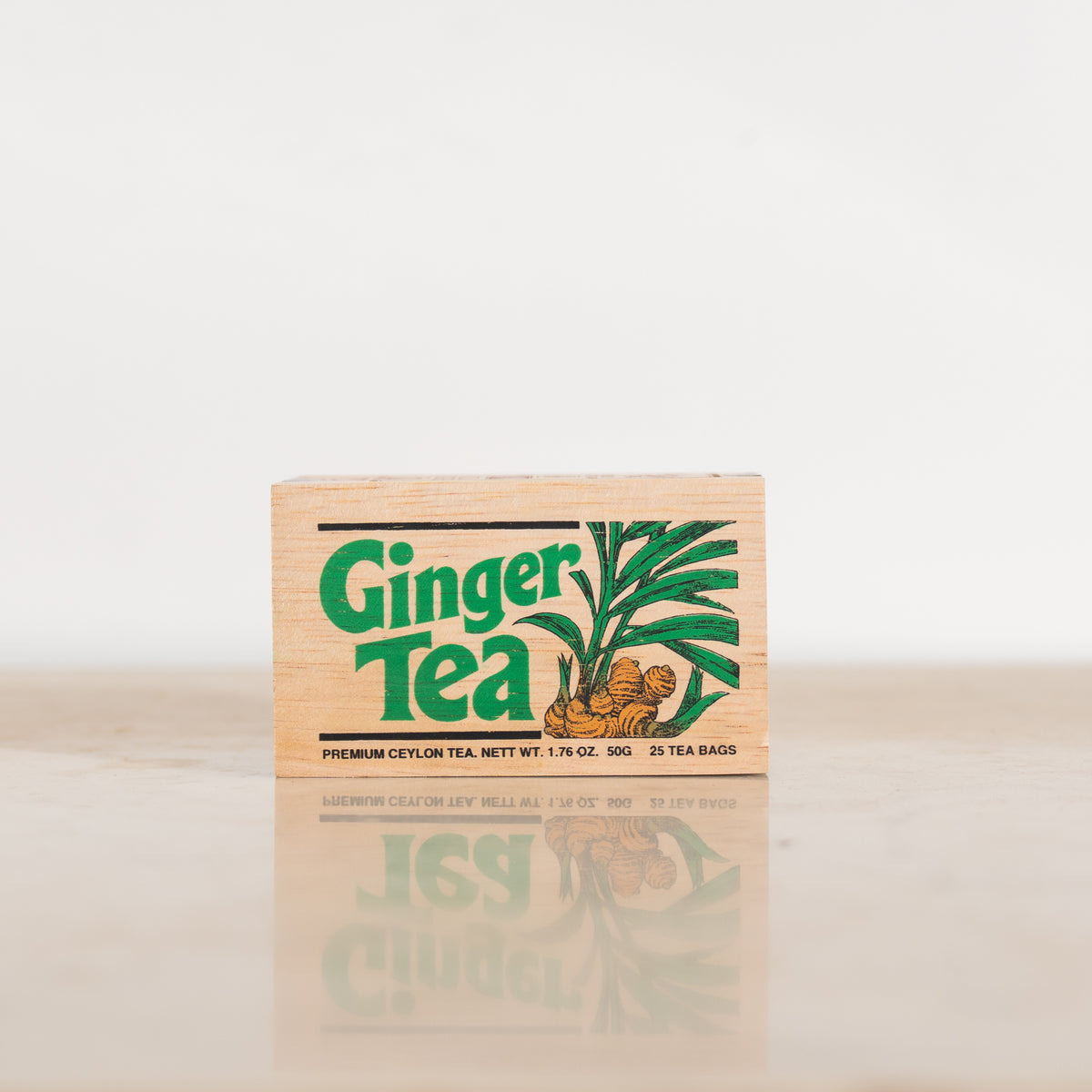 Front view of a wooden tea box featuring the text "Ginger Tea" next to an illustration of a ginger root.