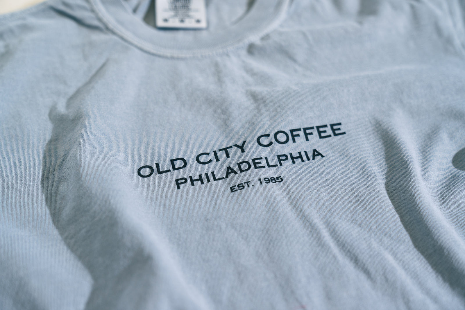 Gray t-shirt with 'Old City Coffee Philadelphia' text on a plain background