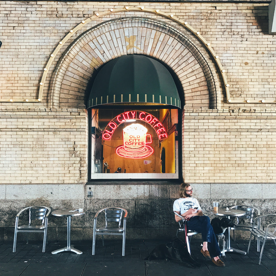 Looking at the Old City Coffee neon sign through the window from outside of the Reading Terminal Market on Arch Street.