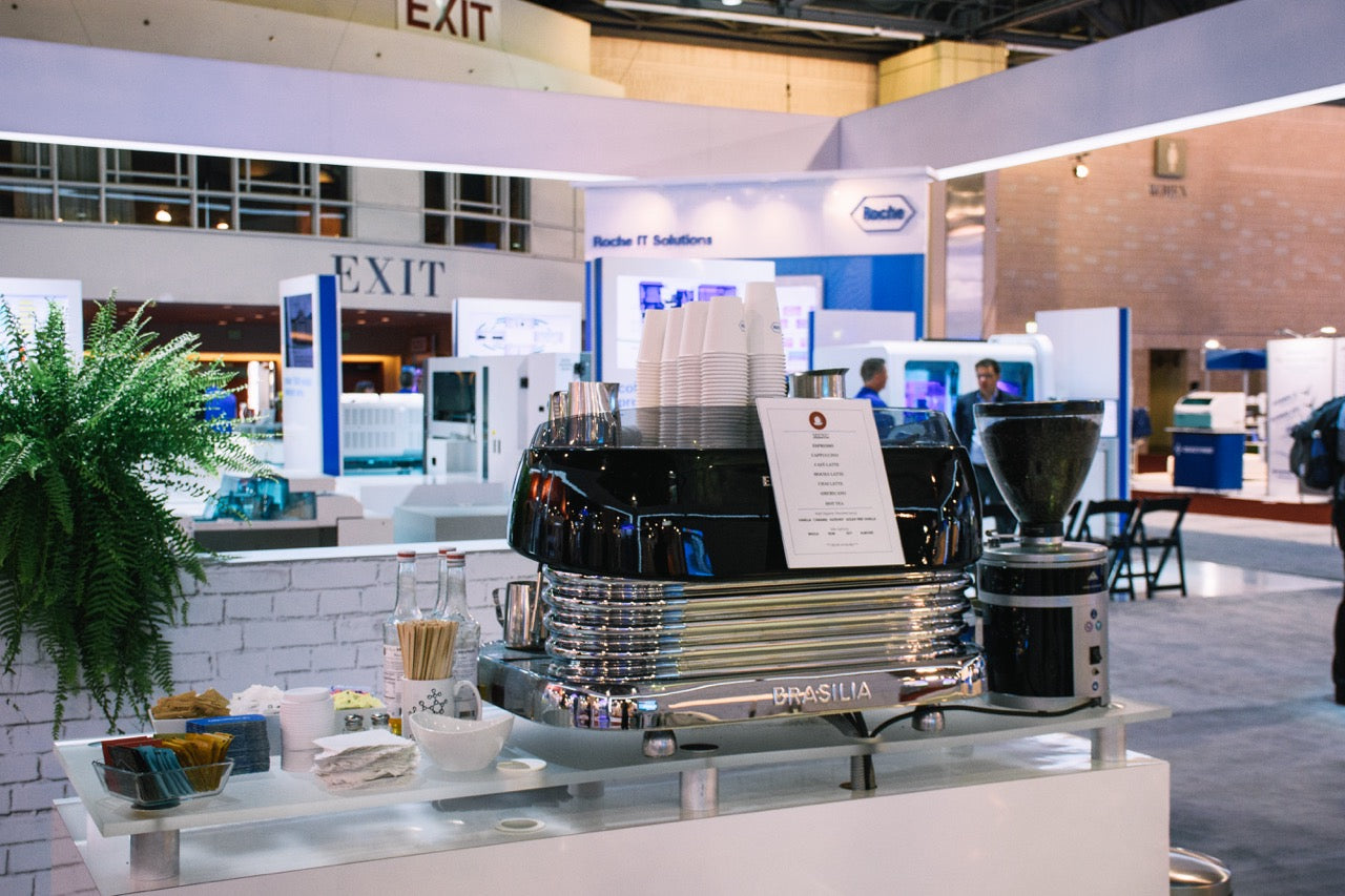 Old City Coffee catering station at an industry conference, which includes an espresso machine and grinder on a table