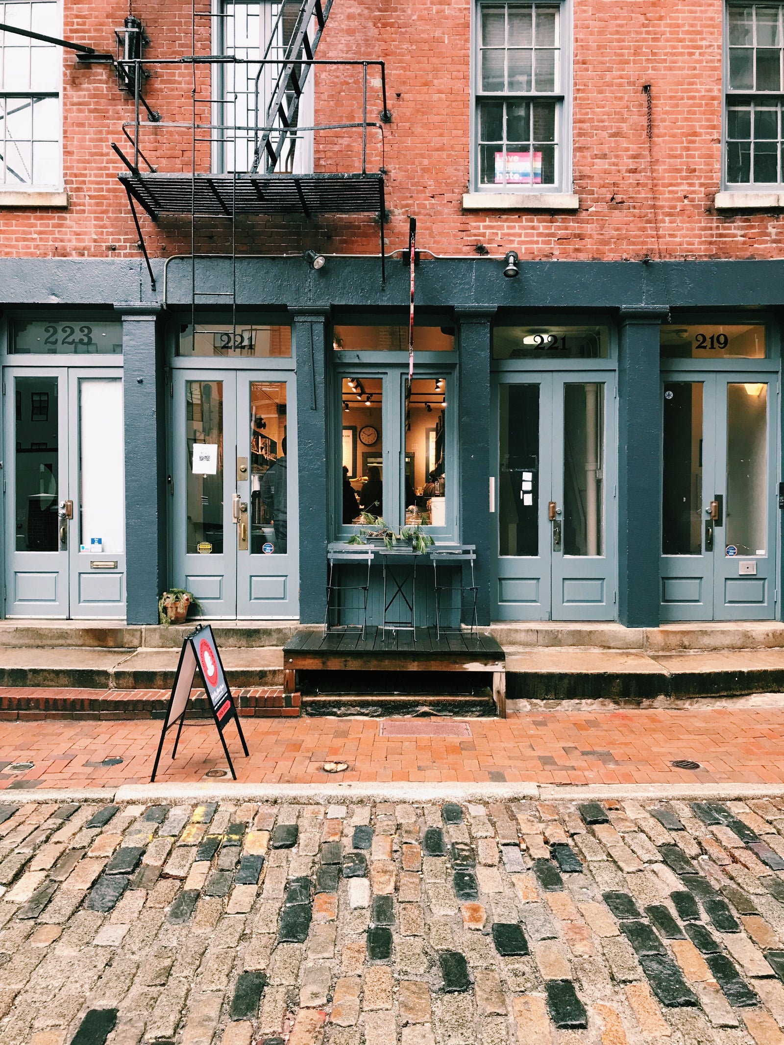Old City Coffee cafe on a cloudy autumn day with a table and chair outside.