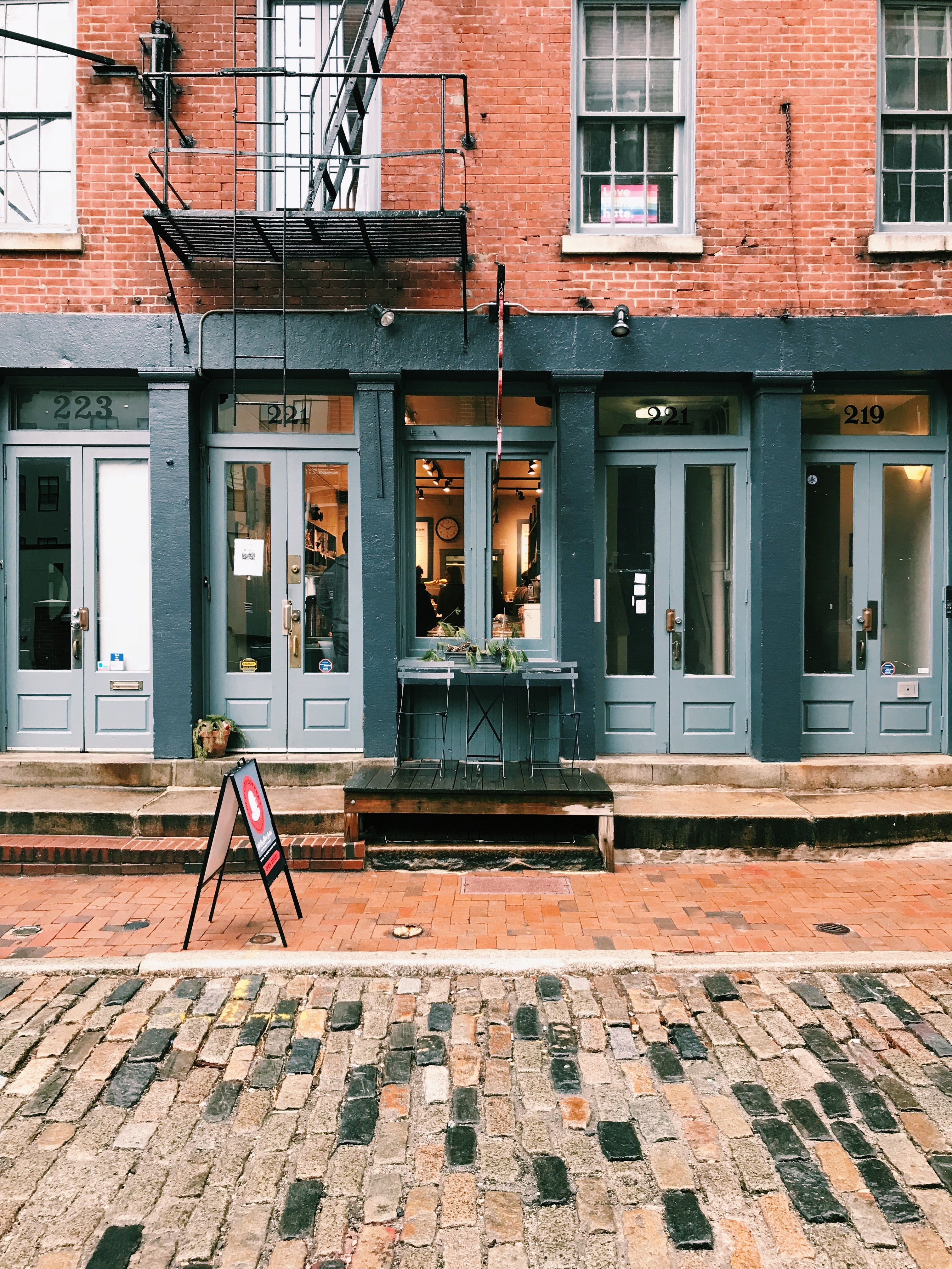 Old City Coffee cafe on a cloudy autumn day with a table and chair outside.