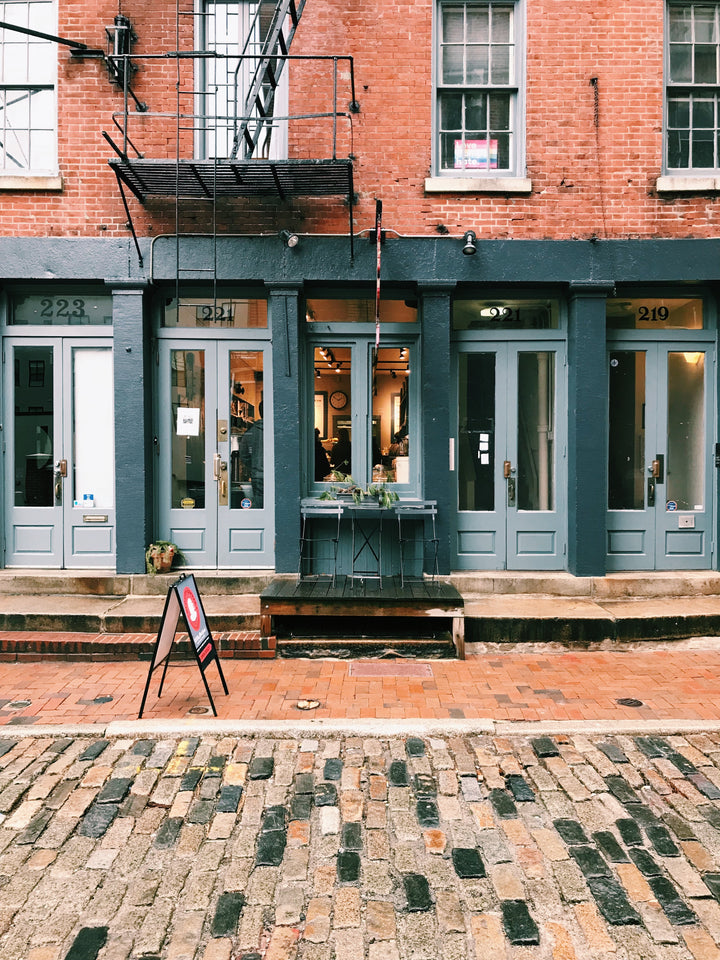 Old City Coffee cafe on a cloudy autumn day with a table and chair outside.