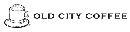 The horizontal logo of Old City Coffee, featuring a black line art drawing of a steaming coffee cup on a saucer next to the brand name in uppercase serif letters on a solid white background.