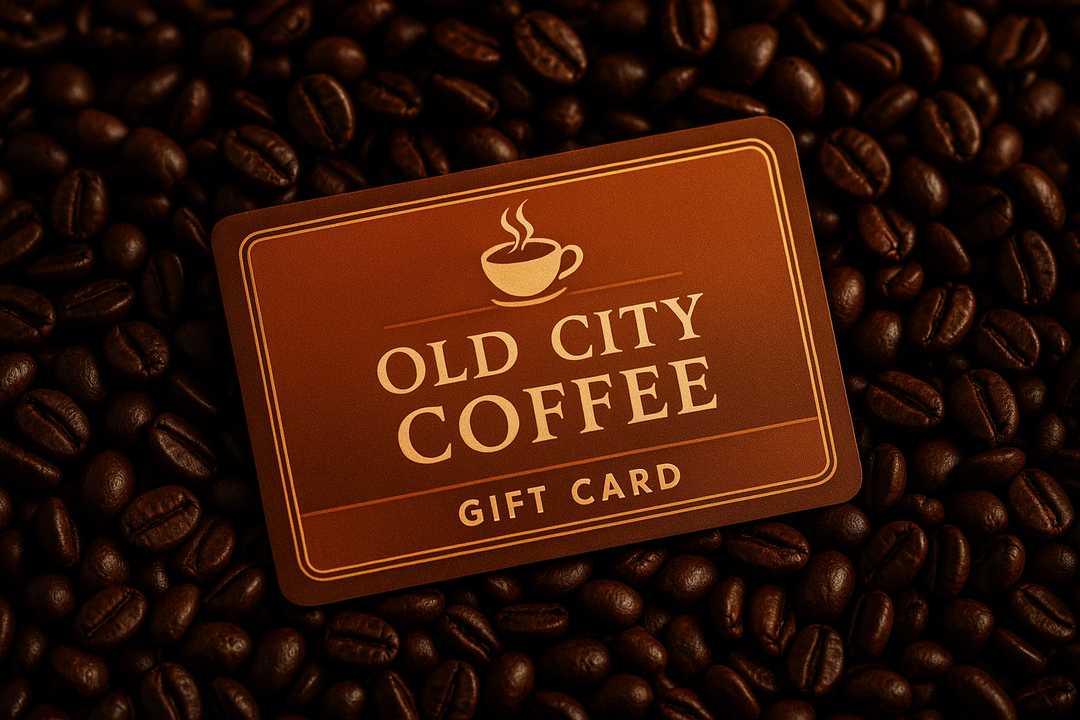 A gift card for Old City Coffee laying in a bed of coffee beans 