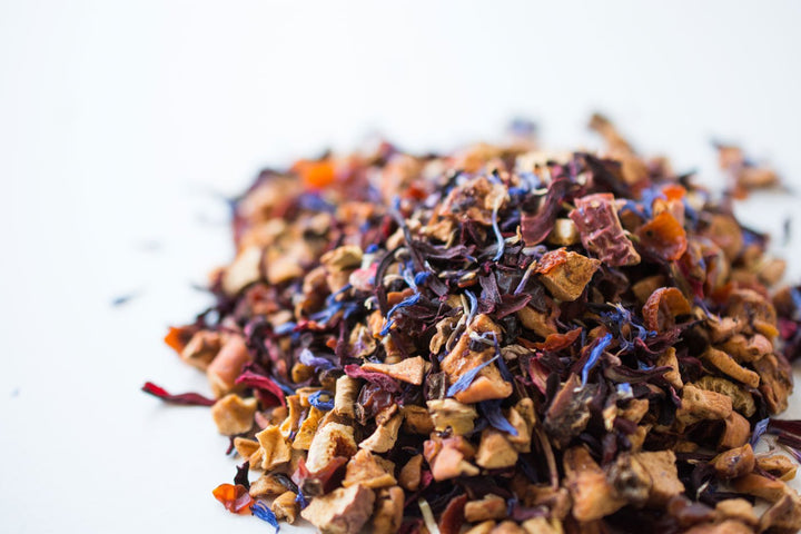 Pile of loose Blue Eyes herbal tea blend on a white surface