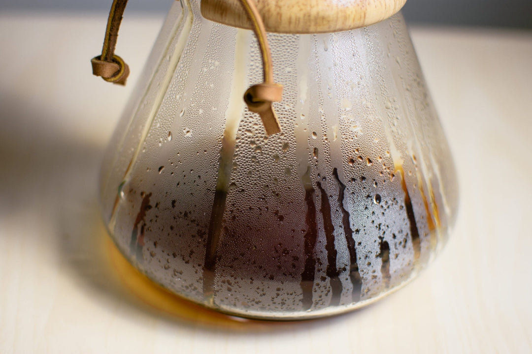 Close-up of the Chemex glass while coffee brews, drips running down the inside