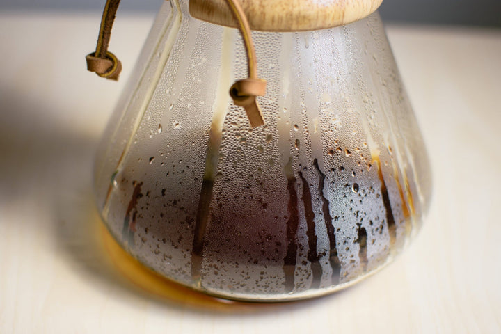 Close-up of the Chemex glass while coffee brews, drips running down the inside