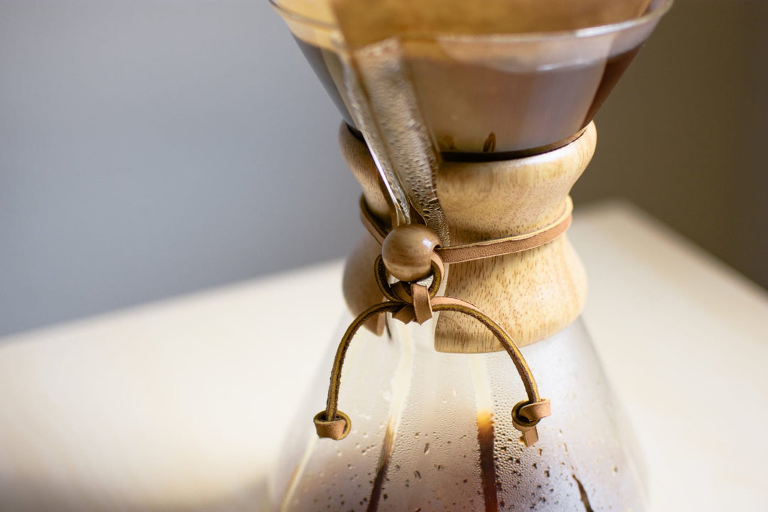 Close-up of the Chemex wood collar and leather tie while coffee brews