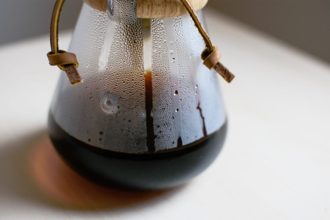 Close-up of coffee brewing in the Chemex, drips running down the glass