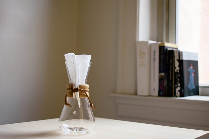 Chemex 3 cup with paper filter on a desk in front of a window