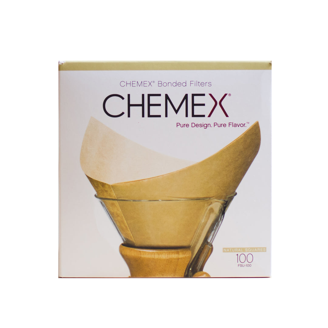 Box of 100 Chemex bonded square filters with a folded natural paper filter in front