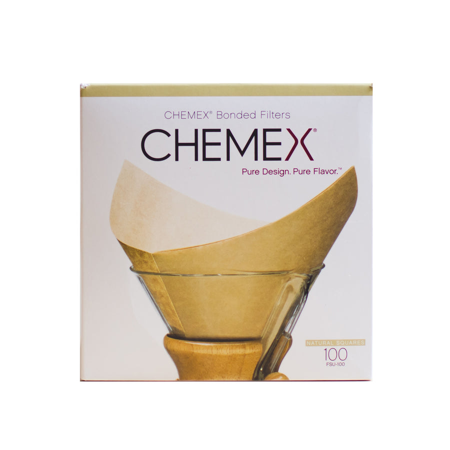 Box of 100 Chemex bonded square filters with a folded natural paper filter in front