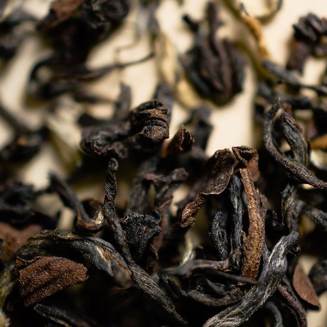 Macro view of dark twisted Darjeeling tea leaves
