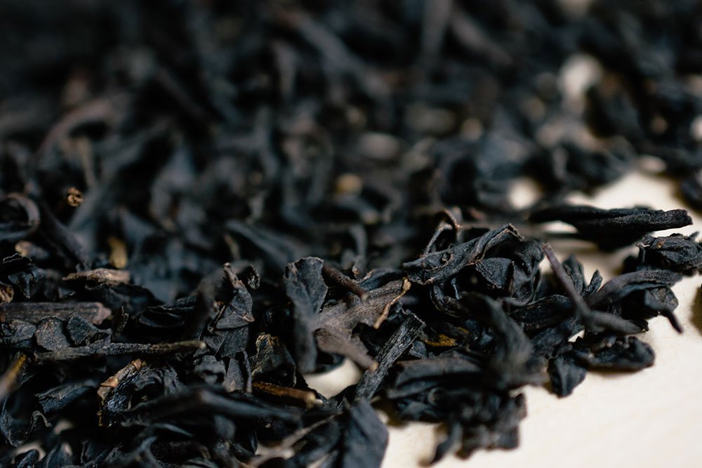 Loose Earl Grey tea leaves scattered in close-up