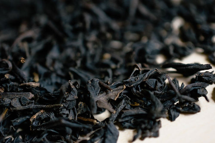 Loose Earl Grey tea leaves scattered in close-up
