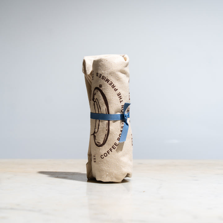 Kraft Old City Coffee bag rolled and tied with a blue ribbon