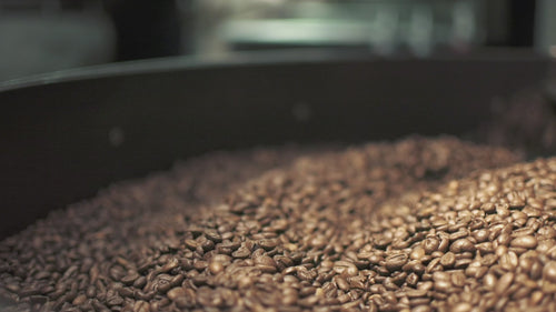 Video of freshly roasted coffee being mixed in a cooling tray. 